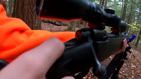 Slow-motion-footage-of-young-hunter-in-orange-taking-his-gun-off-safe