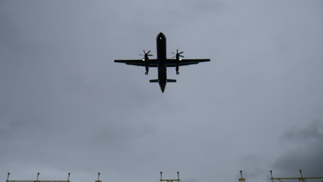 Propellor-plane-flying-over-approach-lights