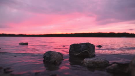 Big-Rocks-In-Lake-at-Orange-and-Pink-Sunset