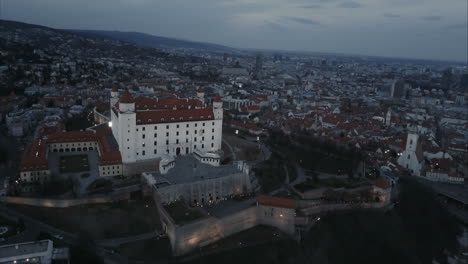 Wide-Aerial-shot-of-Bratislava-castle-and-old-town-at-twilight