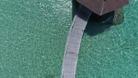 Aerial-of-a-pier-in-the-ocean-with-a-gazebo-in-the-ocean