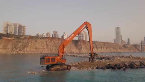 truck-brings-large-stones-to-Hitachi-Construction-Long-Reach-to-build-a-stone-pier