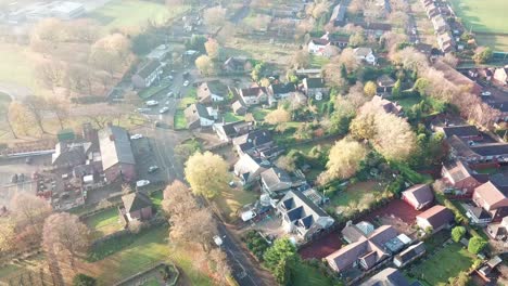 Reverse-aerial-shot-above-UK-rural-village---church-countryside