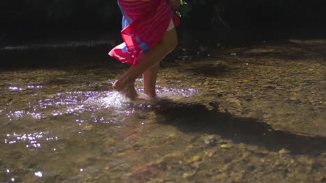 Slow-motion-of-a-woman's-feet-walking-in-a-shallow-river