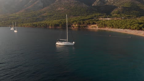 Aerial-orbit-of-a-sailboat-off-the-coast-of-the-famous-Zlatni-Rat-on-the-island-of-Brac-in-Croatia
