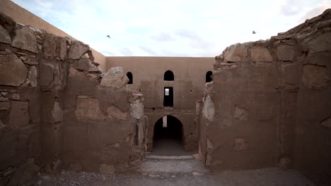Second-Floor-of-Qasr-Kharana-Desert-Castle-With-Two-Birds-Flying-into-Each-Other-on-the-Far-Side-of-Csatle-Interior