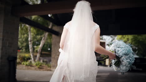 Bride-walking-outside-in-a-beautiful-white-dress
