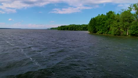 Drone-footage-of-the-Mosquito-Lake-shoreline-on-a-clear-day-with-blue-sky-and-white-clouds
