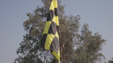A-black-and-yellow-checker-golf-flag-with-subtle-movement