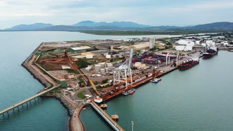 Drone-footage-slowly-circling-marine-port-facilities-in-Townsville,-Australia