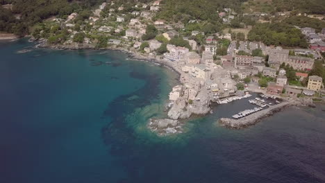 Aerial-footage-of-the-ancient-Tower-and-Harbor-of-Corsican-city-Erbalunga,-France