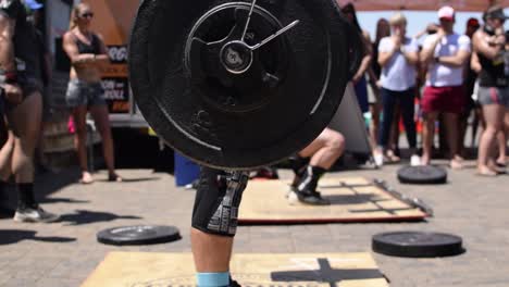An-Adult-Crossfit-Athlete-Completing-a-Dead-Lift-at-a-Crowded-Competition