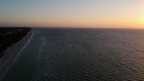 Flying-toward-the-beach-on-Sanibel-Island-looking-down-the-shore-toward-lighthouse-point