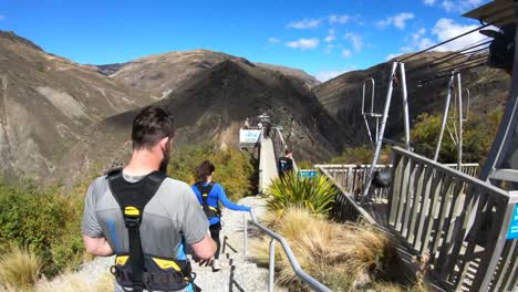 Walking-out-to-the-platform-to-bungy-jump-at-the-Nevis-Bungee-jump-site-in-Queenstown-New-Zealand