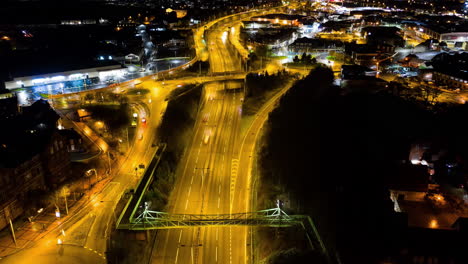 An-aerial-view-of-a-night-time-time-lapse,-timelapse-of-the-A50,-A500-dual-carriage-way,-motorway-in-the-heart-of-the-midlands-area-of-Stoke-on-Trent,-Staffordshire