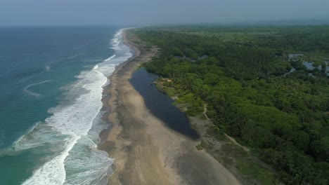 Aerial-shot-of-the-beach,-the-lagoon-and-the-mangroves-of-La-Ventanilla,-Oaxaca