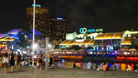 Singapore---Circa-Time-Lapse-boat-traffic-and-crowds-move-in-and-out-of-the-Clarke-Quay,-Singapore