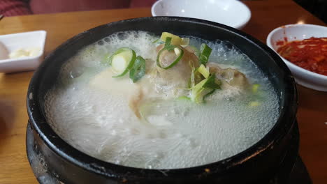Ginseng-chicken-or-samgyetang-served-boiling-on-a-hotpot
