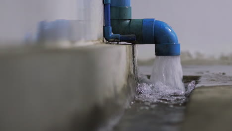 Starker-Regen-Verursacht-Einen-Starken-Wasserfluss-Aus-Einem-Blauen-Abwasserrohr