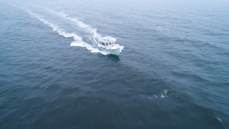 Frontal-aerial-view-of-a-boat-speeding-across-the-waters