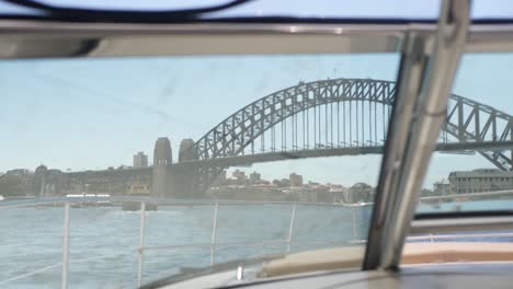 View-inside-a-boat-from-the-windows-approaching-the-harbor-bridge-in-Sydney