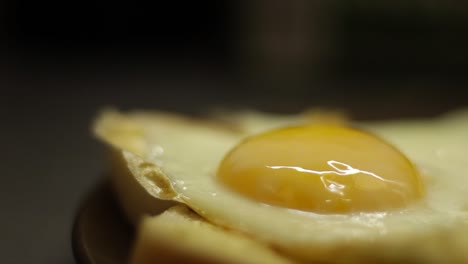 Close-up-shot-of-tomato-sauce-being-pored-onto-a-fried-egg
