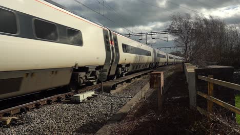 Footage-of-trains-approaching-Stoke-on-Trent-train-station-in-the-midlands-by-the-canal,-waterside-and-A50-motorway