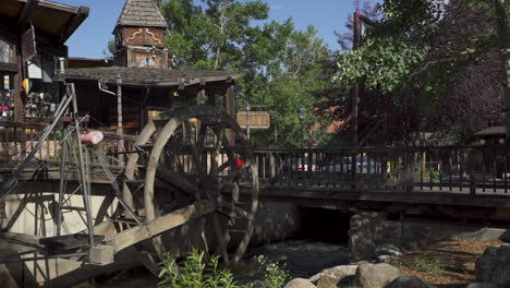 Tilt-up-shot-of-an-old-antique-water-wheel-in-a-small-tourist-town-in-Colorado