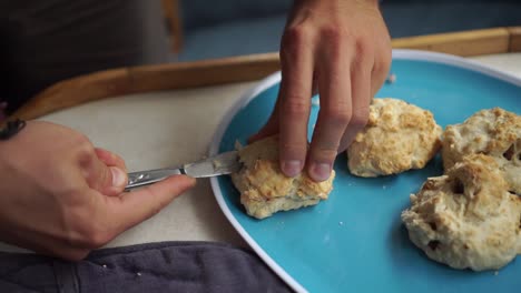 SLOWMO---Caucasian-man-cuts-freshly-baked-traditional-New-Zealand-scone
