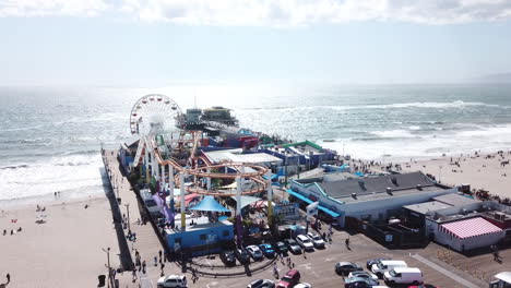 Santa-Monica-Pier-dock-with-carnival-fair-rides-and-a-parking-lot