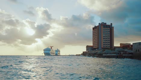 Low-angle-static-shot-of-a-large-cruise-ship-docked-in-Willemstad,-Curacao,-at-sunset-in-the-Caribbean
