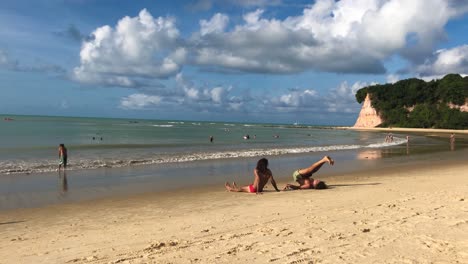 Junges-Paar-Trainiert-Am-Strand-Mit-Einem-Bewölkten-Himmel-Als-Hintergrund