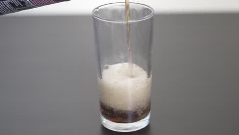 Filling-up-a-clear-glass-with-Soda