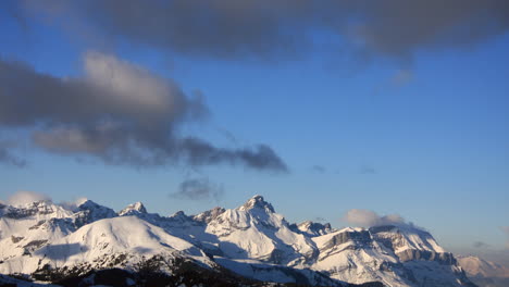 Time-lapse-showing-clouds-moving-over-the-mountain-of-Pointe-Percée-in-the-French-Alps-in-winter-with-evening-light