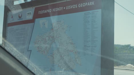 Tourism-route-map-of-Lesvos-island-looking-through-gritty-car-window-screen