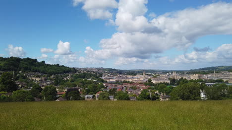 Left-to-Right-Pan-Shot-of-the-City-of-Bath-Skyline-from-Hillside-Lookout-on-a-Sunny-Summer’s-Day-with-Blue-Sky---White-Fluffy-Clouds