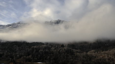 Time-lapse-of-low-cloud-in-a-valley-slowly-clearing-to-reveal-mountain-tops-in-the-background