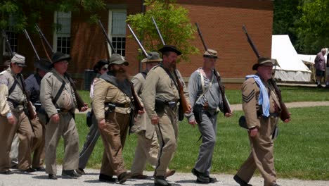 Confederate-soldiers-march-on-a-path-to-camp