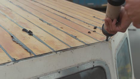 sealing-cabin-roof-of-wooden-boat-using-sika-flex-sealant-gun