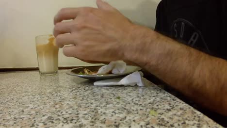 Time-lapse-of-a-person-having-lunch-eating-an-hamburger-and-milkshake-inside-a-take-away-restaurante