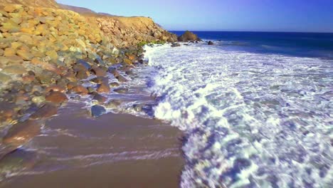 Aerial-pull-back-shot,-Point-Mugu-in-Santa-Monica,-sunny-day,-California,-USA