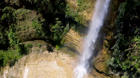 Aerial-shot-of-giant-tropical-waterfall-collects-in-a-pool-below
