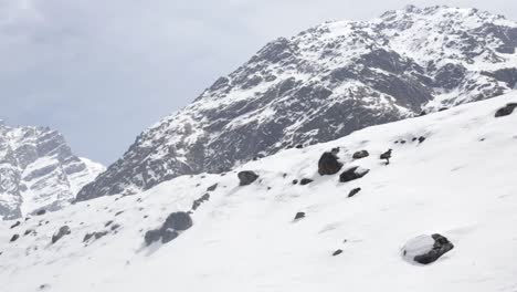 Una-Vista-De-La-Montaña-Nevada-Del-Himalaya,-Uttarakhand-India-Y-Montañeros-Escalando-Las-Montañas-Nevadas-En-Gran-Número