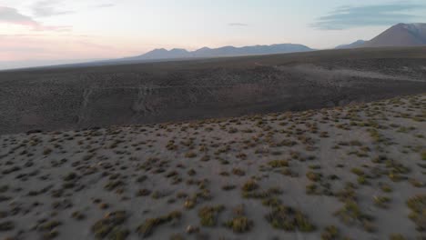 Aerial-cinematic-approach-of-a-canyon-in-Atacama-Desert-at-sunset