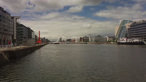 River-Liffey-and-city-landscape-drone-shot,-flying-aboard-River-Liffey-to-see-the-skyline