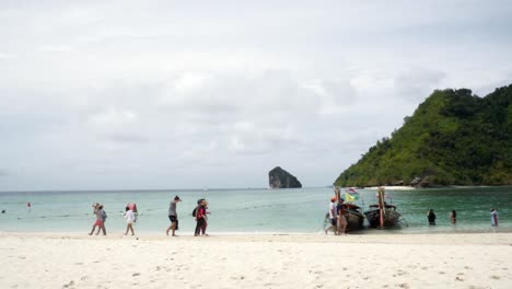 Travelers-travel-to-the-island-by-boat-to-see-the-beauty-and-sunbathing-at-the-beach-front,-with-a-long-beach,-suitable-for-swimming-at-Krabi-in-Thailand