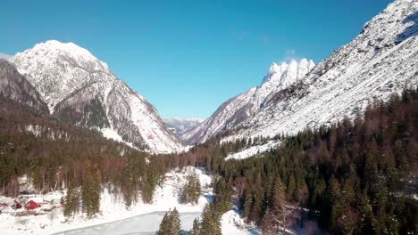Lago-del-Predil,-Tarvisio---Italy-a-frozen-alpine-lake-in-a-snow-covered-winter-fairytale-mountain-landscape