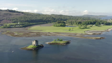 An-aerial,-high-view-of-Castle-Stalker-on-Loch-Laich-on-a-sunny-morning