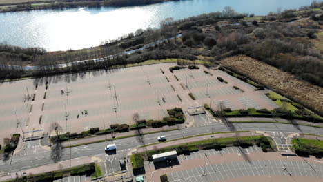 Aerial---A-parking-lot-in-a-park-nearby-lakeside