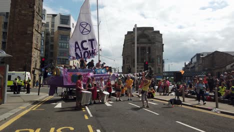 Extinction-Rebellion-protesters-finishing-off-a-song-in-front-of-a-small-crowd